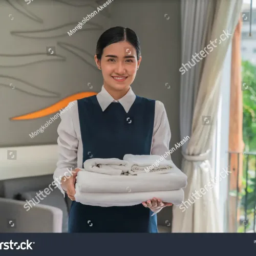 stock-photo-portrait-of-asian-hotel-maid-holding-fresh-towels-prepare-for-new-hotel-guest-in-bedroom-1928753789